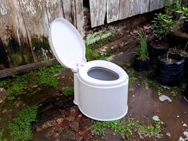 A white toilet sitting in a puddle of water photo