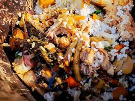 A pile of food that is in a brown container photo