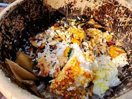 A bowl of food that has been sitting on the ground photo