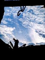 A silhouette of a person looking up at the sky photo