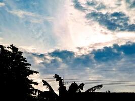 A plane flying in the sky with clouds photo