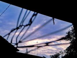 A view of a sky with a kite flying in the background photo
