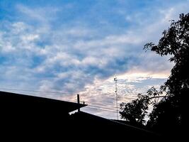 A plane flying in the sky with a cloudy sky photo