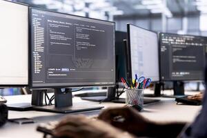 Data center technician using programming languages on PC to construct algorithms and build applications. Close up of server hub IT professional debugging and optimizing code photo