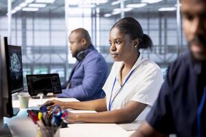 Data center engineers using programming languages to construct algorithms and build applications. Server hub workers designing and deploying software architectures, debugging and optimizing code photo