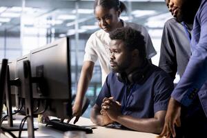 Team of data center employees working together to create technical documentation for software applications. Server room colleagues doing brainstorming, maintaining databases photo