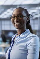 Portrait of happy african american computer scientist programming in AI data center used for machine learning training. Jolly IT expert working on artificial intelligence tech in server hub office photo