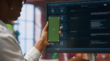 Woman at home holding mockup smartphone asks questions to AI LLM virtual assistant answering prompts. Person with chroma key phone receiving information from artificial intelligence GPT, camera B photo