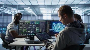 Computer scientist in data center uses artificial intelligence neural networks doing computing processes. IT specialist working on tablet with AI machine learning algorithms, camera B photo