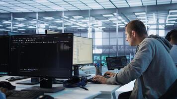 Technician arriving at work in high tech server room, analyzing data on monitors, ensuring seamless data flow. Man starting job shift in data center, ensuring system integrity and security, camera B photo