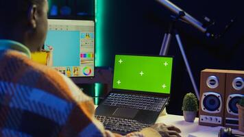 African american expert using AI neural network to develop a software with chroma key, cloud computing. IT programmer showing his dedication in cyber security, machine learning. Camera B. photo