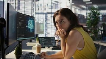 Woman in office using laptop to steal company secrets after being hired by competitor, hiding from manager. Sneaky employee closing notebook lid to hide while ilegally downloading data, camera B photo