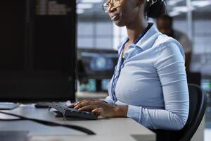 Admin implementing cybersecurity measures to protect data center assets and information. Employee monitoring and analyzing server room metrics to enhance operational effectiveness photo