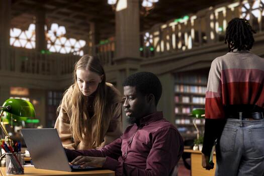 Multiethnic pupils working on a team project assignment at the campus library, consulting the academic database and research collection with various books. Young adults guarantee high grades. photo
