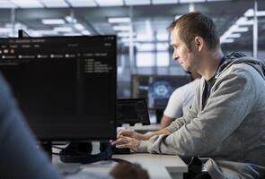 Man getting PC crash while trying to fix error in high tech data center workplace, solving tasks. Server farm worker trying to repair bugs in mainframes, typing on computer keyboard photo