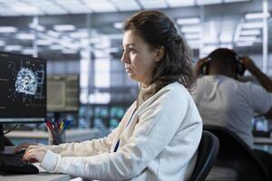 Computer scientist programming in AI data center used for machine learning training. IT professional in server hub running code on PC to upgrade artificial intelligence technology photo