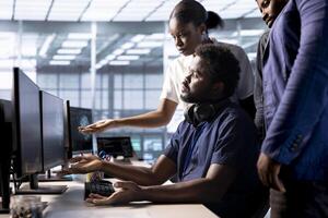 Team of data center programmers using programming languages to construct algorithms and build applications. Group of server hub employees working together on debugging and optimizing code photo