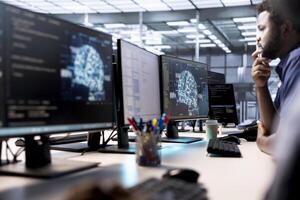 Computer scientists in data center using artificial intelligence system monitoring software to identify errors. Machine learning specialist in AI server farm establishment repairing equipment photo