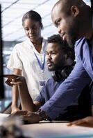 Team of cybersecurity experts monitoring security incidents affecting server hub network, working together. Engineering coworkers doing brainstorming in data center protecting company from threats photo