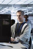 IT professional optimizing data center gear for maximum efficiency and uptime. Software developer in server hub maintaining optimal network performance, performing backups photo