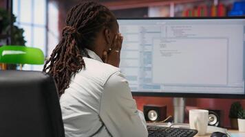 Disappointed engineer in home office looking at UI on computer monitor, failing to properly execute programming code. Displeased IT worker seeing errors while using coding application, camera B photo