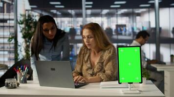 Female CEO engaging in project management using green screen to set goals and objectives, solve problems and track performance metrics of the company. Administrative tasks and decisions. Camera B. photo