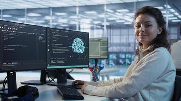 Portrait of smiling technician programming in AI data center used for machine learning training. Cheerful IT expert running code to upgrade artificial intelligence tech, camera B photo