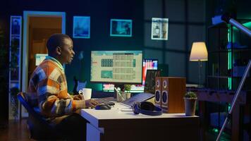 African American man having discussion during online meeting on laptop, talking about internet statistics or data. Freelancer use technology for virtual communication, working remotely. Camera B. photo