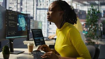 Tired african american programmer having strained eyesight from overworking in office. Close up of woman at work removing eyeglasses to rub eyes, looking at PC screen for too long, camera B photo