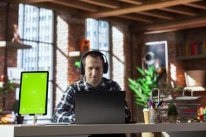 Focus on isolated screen tablet used by worker in blurry background participating in online training session in home office. Close up of chroma key device used by man watching instructional videos photo