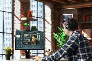 Person in home office uses generative artificial intelligence GPT with image understanding capabilities generating videos. Man using AI virtual assistant outputting high resolution lifelike visuals photo