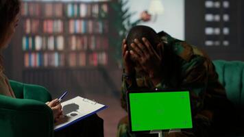 Military soldier experiences shell shock at counseling next to copy space, dealing with trauma recovery and share his feelings. Army trooper with PTSD and combat flashbacks scenes. Camera B. photo