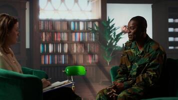 Counselor offering support to war veteran during therapy session, suffering from bipolar disorder and shell shock. Distraught serviceman dealing with war flashbacks, traumatic experiences. Camera b. photo