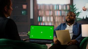 Diverse secret agents discussing next to isolated chroma key on screen, meeting in the CIA headquarters library to discuss important mission details. Secure information for national safety. Camera A. photo