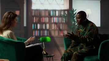 Military war veteran is in a vulnerable state opening up about combat horror scenes, crying and feeling frustrated after losing troopers. Serviceman discussing about traumatic experiences. Camera B. photo