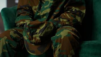 Armed forces trooper deals with depersonalization syndrome due to combat PTSD, feeling distressed and dissociative during therapy session. Black soldier with shell shock and trauma. Camera B. photo