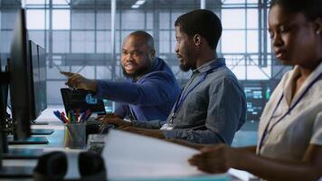 Data center engineers maintaining company network infrastructure by installing, configuring, troubleshooting and repairing hardware. Server hub workers ensuring optimal system performance, camera A photo