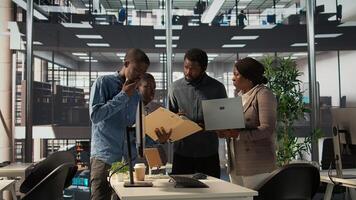 African American team collaborates on a financial planning project in a business space, emphasizing teamwork and data analysis to make informed decisions for future firm growth. Camera B. photo