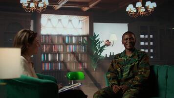 Portrait of army trooper meeting with a counselor to discuss about anxiety and distress due to PTSD and battle trauma, shell shock and mental disorder. Depressed trooper at counseling. Camera B. photo