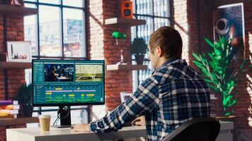 Remotely working videographer doing montage using specialized software applications. editor using editing tools on PC to cut movie project footage in home office, camera B photo