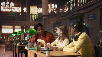 Teacher assisting scholars with class homework for mentoring session, providing academic instruction and support to help with the curriculum. Tutor lecturer gives private lessons. Camera A. photo