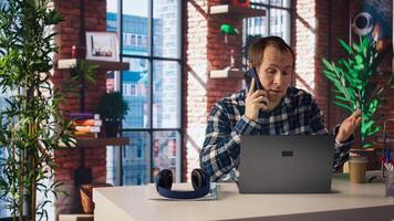 Manager in home office sitting at desk in front of laptop, calling employee to confront him about mistakes. Supervisor using notebook to do job online, doing telephone call to scold worker, camera A photo