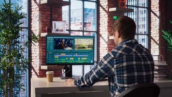 Remotely working videographer doing montage using specialized software applications. editor using editing tools on PC to cut movie project footage in home office, camera A photo