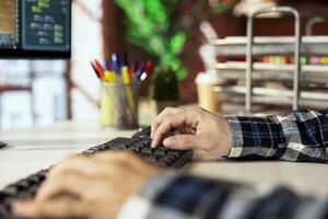 Man at home playing simulation videogame, moving 3D assets, doing interior design. Person having fun playing interior designer character in game on computer, making home floor plans photo