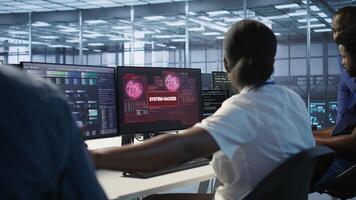 Team of engineers in server hub trying to protect gear from hacker stealing sensitive information. Data center coworkers struggling to erase virus after seeing security breach notification, camera A photo