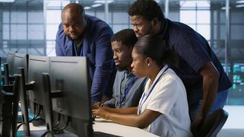 Coworkers in data center doing brainstorming, implementing AI predictive maintenance systems. Server hub colleagues discussing, using artificial intelligence to identify hardware failures, camera A photo