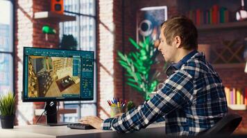 Architectural designer in home office moving assets in 3D modeling program, doing interior design project. Man looking at CAD software interface on PC, making home floor plans, camera B photo