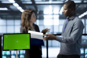 Mockup tablet used by data center technicians in blurry background reviewing hardware diagnostics. Close up of isolated screen device used by employees adjusting device configurations photo