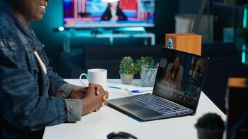 Remote worker talks with board of directors during videocall business meeting from home office. Teleworker speaks in remote videoconference telework call, receiving feedback from management, camera A photo