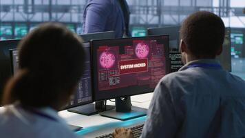Cybersecurity team monitoring security incidents, alerted by security breach alert, working together to get rid of virus, protecting infrastructure from threats, camera A photo